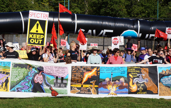 Pipeline protesters with simulated pipeline