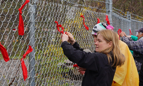 Red ribbons at rally against Spectra plant