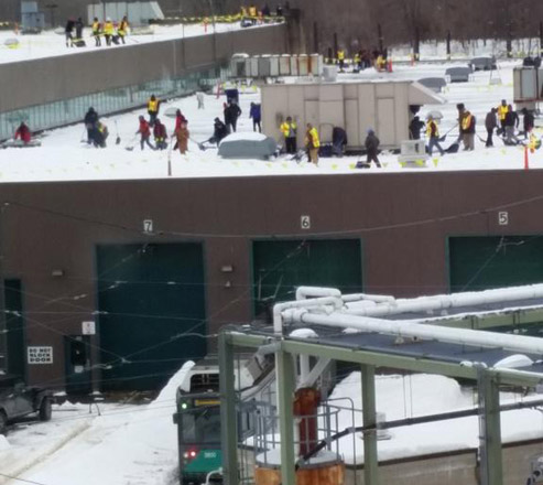 Workers on the roof of the Riverside trolley barn