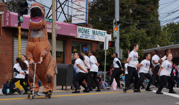 Dinosaur and dancers in Roslindale Day Parade