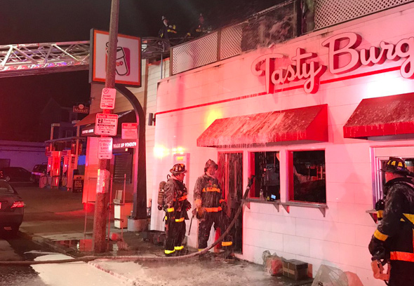 Firefighters at South Boston Tasty Burger after fire