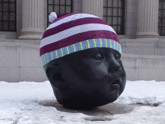 Giant baby head with giant baby hat