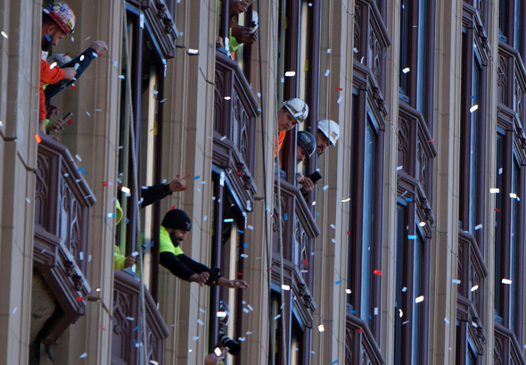 Construction workers watch Patriots go by