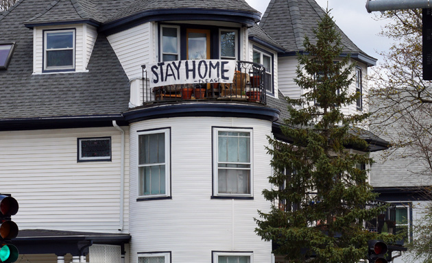 Banner in Roslindale that says: Stay home!