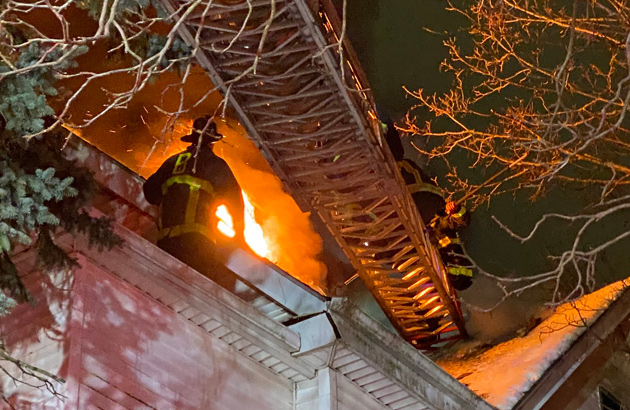 Firefighter on roof at Glenway Street