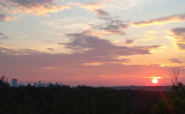 Orange sunrise over Peters Hill in the Arnold Arboretum and downtown Boston