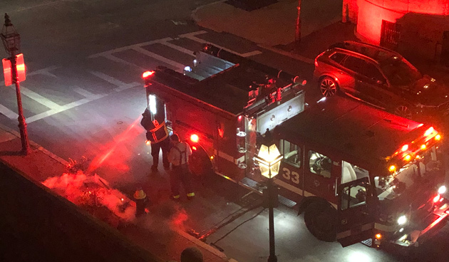 Firefighters putting out burning trash, trees and a wreath in the Back Bay