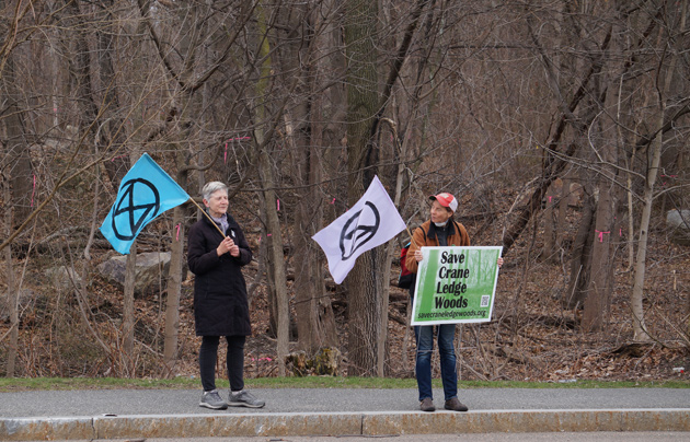 Protesters in front of the woods