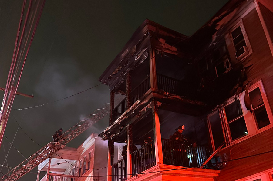 Firefighters at burned out 128 Capen St.