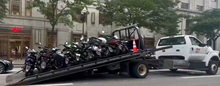 Mopeds about to be hauled off
