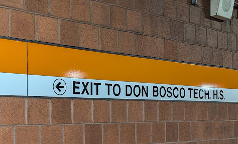 Wayfinding sign pointing Orange Line riders to Don Bosco Technical High School