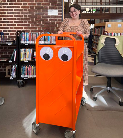 Googly-eyed book cart at Jamaica Plain library