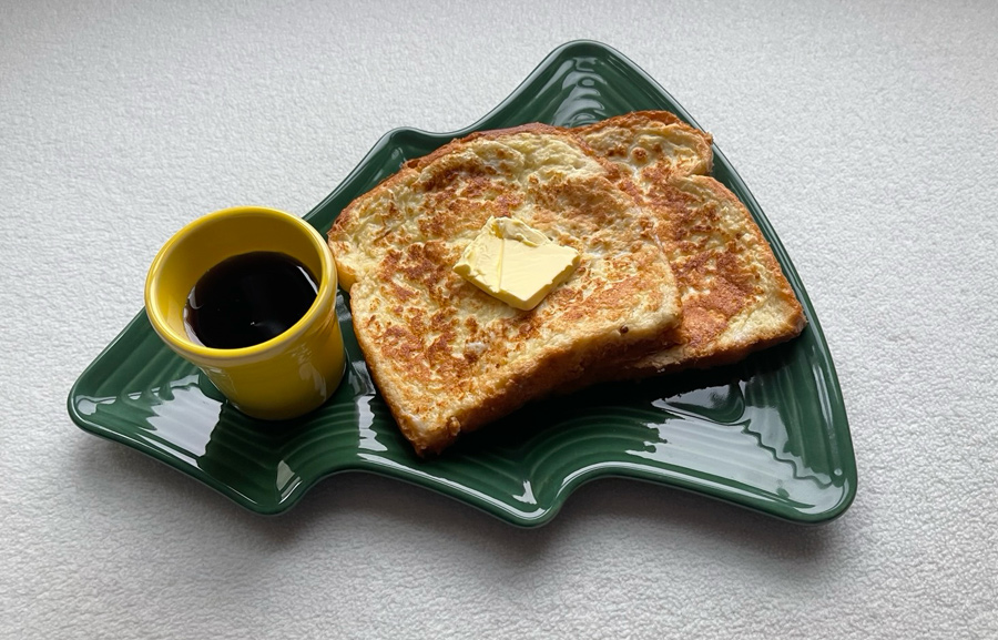 French toast with syrup on a Christmas-tree plate