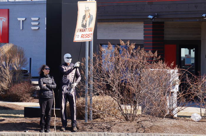 Man dressed as skeleton protests Teslas