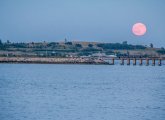 Strawberry moon over Pleasure Bay in South Boston