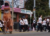 Dinosaur and dancers in Roslindale Day Parade