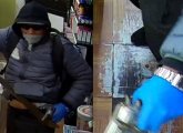 Man with machete and gun and distinctive watch