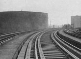 Molasses tank as seen from elevated railroad along Commercial Street