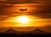 Sunset and jet over the Tobin Bridge