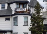 Banner in Roslindale that says: Stay home!