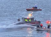 Boston and Massport fire crews pour water on burning boat