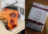 Bloody-pig-head mask and grief book