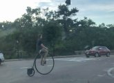 Guy riding a penny farthing in Forest Hills