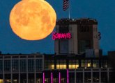 Moon sets over the Schrafft's Building in Charlestown