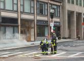 Firefighters at manhole explosion scene