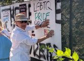 Covering hateful graffiti with pro-Pryde signs