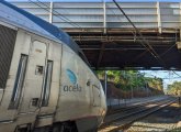 Acela train about to go under bridge