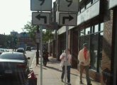 Rte. 9 signs stuck in the middle of a Mission Hill sidewalk