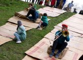 Tromboinists do slides on a slide at Wake Up the Earth