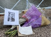 Two bouquets, a note and a photo on the Public Garden bridge