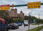 Truck doing the backup of shame on Memorial Drive under signs telling truck drivers to exit