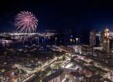 Fireworks over Boston Harbor, with Custom House on the right