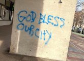 Graffiti on Massachusetts Avenue reading God Bless Our City