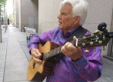 John Davidson with a guitar on Boylston Street outside the BPL