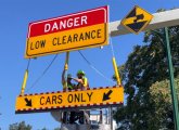 New bright-yellow CARS ONLY sign being installed at Storrow Drive entrance