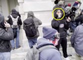 St. Pierre on Capitol steps with a PA system, urging rioters inside