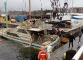 Sunk boat is raised up in Boston Harbor