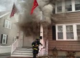 Heavy smoke pouring out of house