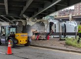 Crew tries to remove storrowed truck at Bowker Overpass