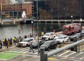 First responders and onlookers gather along Fort Point Channel