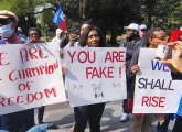 Haitians on the Common with signs supporting the community