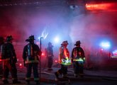 Firefighters outside Henry's Market in Roslindale