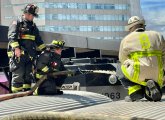 Firefighters on top of a commuter-rail train at North Station