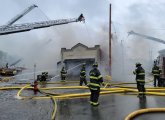 Firefighters pour water on Russo's fire