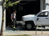 Firefighter walks by pickup in window