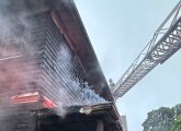 Firefighter, ladder at smoky house on Tip Top Street